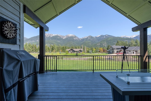 29 Elk Run Trl, Kalispell, MT 59901 - wooden deck featuring area for grilling, a mountain view, and a lawn