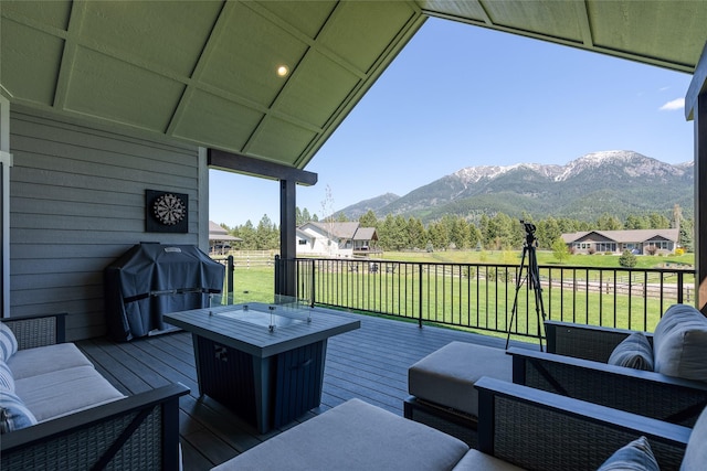 29 Elk Run Trl, Kalispell, MT 59901 - wooden deck with a mountain view, an outdoor living space, a lawn, and a grill