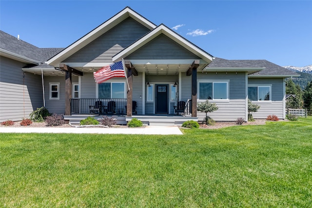 29 Elk Run Trl, Kalispell, MT 59901 - view of front of property with covered porch, a front lawn, and a shingled roof