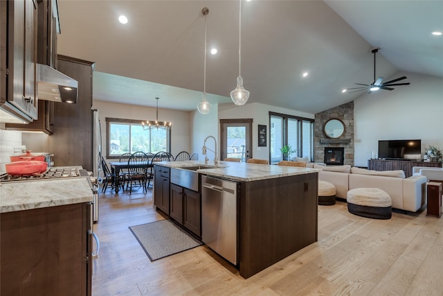 29 Elk Run Trl, Kalispell, MT 59901 - kitchen featuring dishwasher, dark brown cabinetry, a stone fireplace, light wood-style floors, and vaulted ceiling