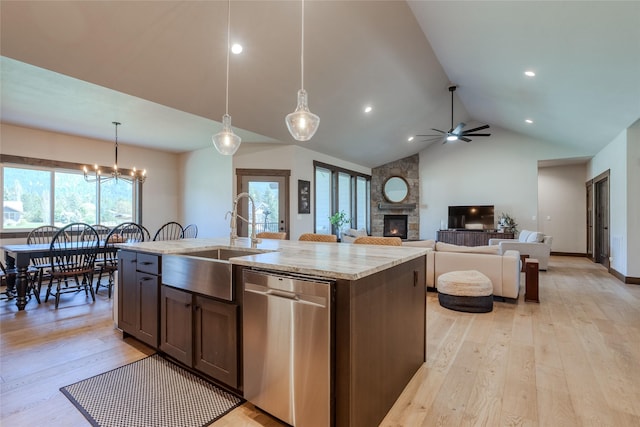 29 Elk Run Trl, Kalispell, MT 59901 - kitchen with stainless steel dishwasher, a stone fireplace, ceiling fan, light wood-style flooring, and high vaulted ceiling