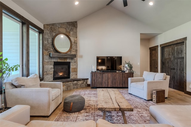 29 Elk Run Trl, Kalispell, MT 59901 - living room with a ceiling fan, a fireplace, wood finished floors, high vaulted ceiling, and recessed lighting