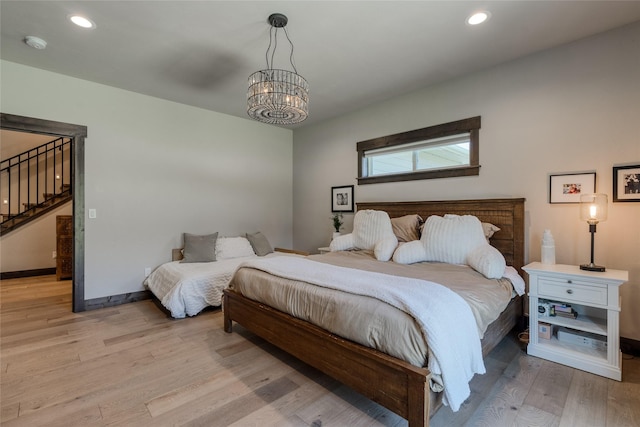 29 Elk Run Trl, Kalispell, MT 59901 - bedroom featuring a chandelier, light wood-style floors, and recessed lighting