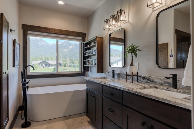 29 Elk Run Trl, Kalispell, MT 59901 - bathroom featuring a soaking tub, double vanity, a mountain view, and recessed lighting