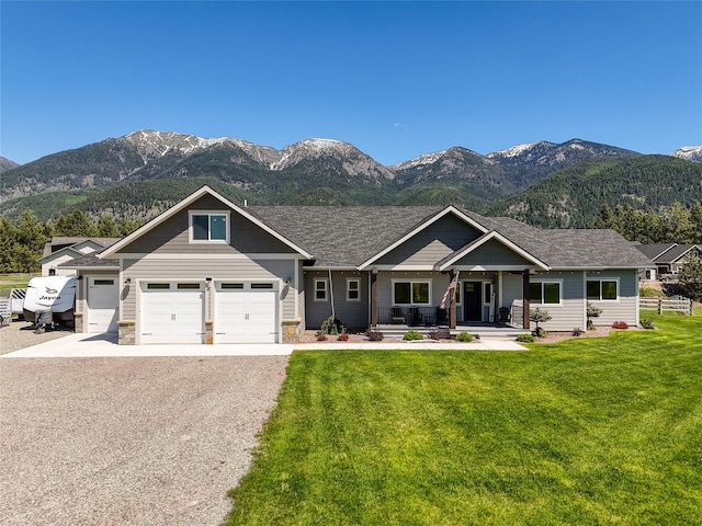 29 Elk Run Trl, Kalispell, MT 59901 - craftsman-style home featuring a mountain view, a porch, gravel driveway, and a front lawn