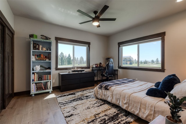 29 Elk Run Trl, Kalispell, MT 59901 - bedroom with multiple windows, hardwood / wood-style flooring, and ceiling fan