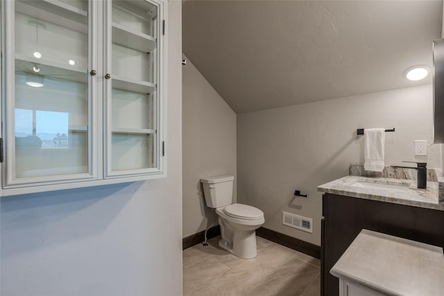 29 Elk Run Trl, Kalispell, MT 59901 - half bath featuring vanity, lofted ceiling, and tile patterned flooring