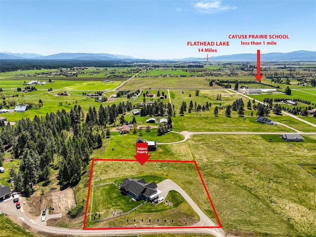 29 Elk Run Trl, Kalispell, MT 59901 - aerial view of sparsely populated area with property boundaries highlighted and a mountainous background