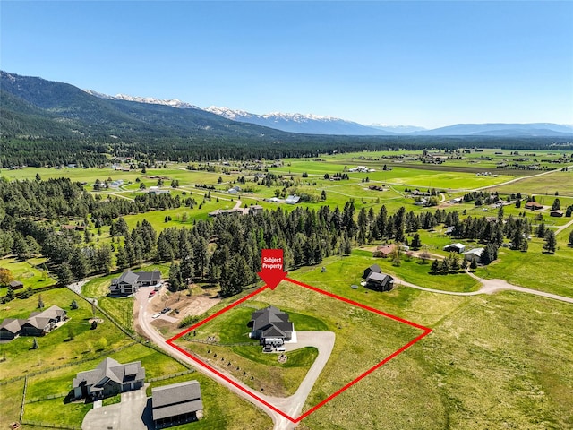 29 Elk Run Trl, Kalispell, MT 59901 - aerial view of sparsely populated area with a mountain backdrop and property boundaries highlighted