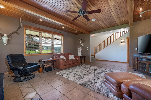 36496 Ridgeway Ct, Polson, MT 59860 - living room featuring wood ceiling with exposed beams, stairway, a ceiling fan, tile patterned flooring, and baseboards