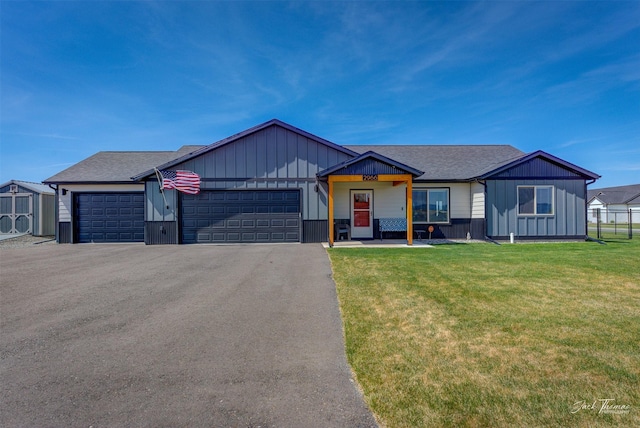 2966 Vermillion Way E, Helena, MT 59635 - view of front facade with a garage, asphalt driveway, a front lawn, board and batten siding, and roof with shingles