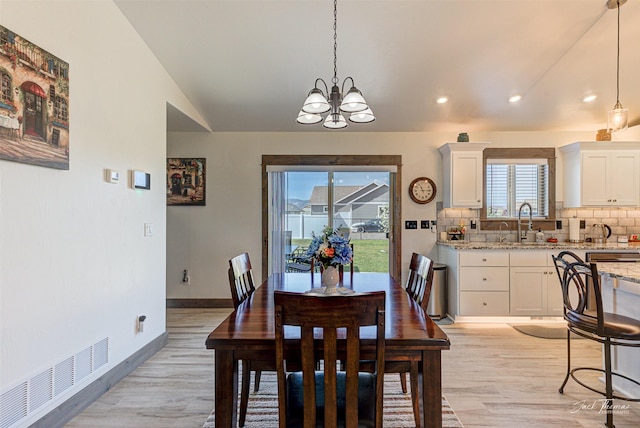 2966 Vermillion Way E, Helena, MT 59635 - dining space featuring light wood-type flooring, a chandelier, vaulted ceiling, and recessed lighting
