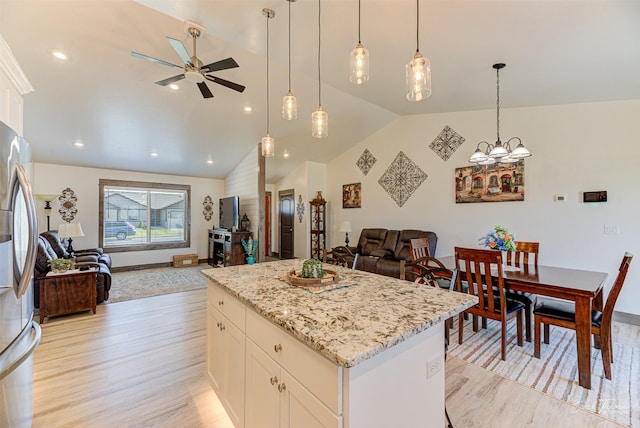 2966 Vermillion Way E, Helena, MT 59635 - kitchen featuring open floor plan, light wood-style floors, lofted ceiling, ceiling fan, and a kitchen island