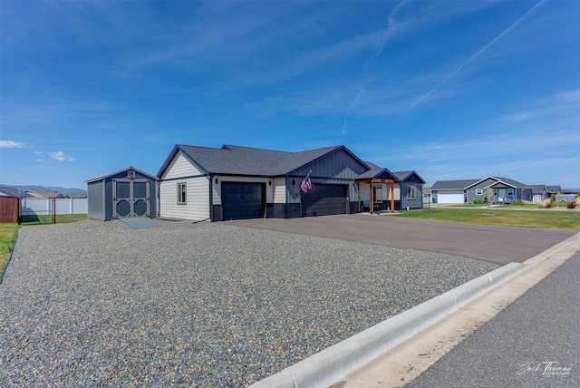 2966 Vermillion Way E, Helena, MT 59635 - view of front of property featuring a garage, a residential view, a shed, and asphalt driveway