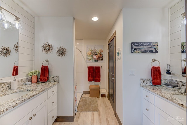 2966 Vermillion Way E, Helena, MT 59635 - full bath featuring wood finished floors, two vanities, a stall shower, and recessed lighting