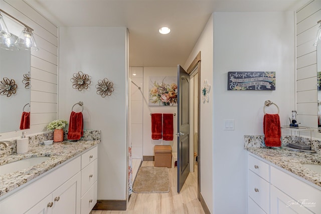 2966 Vermillion Way E, Helena, MT 59635 - bathroom featuring a stall shower, two vanities, recessed lighting, and wood finished floors
