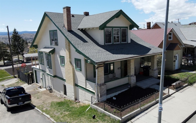 1100 Caledonia St, Butte, MT 59701 - view of front of house with roof with shingles, a chimney, a porch, and a mountain view