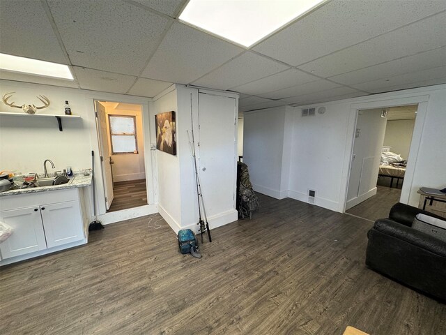 1100 Caledonia St, Butte, MT 59701 - finished below grade area featuring a paneled ceiling, dark wood-style flooring, baseboards, and a sink