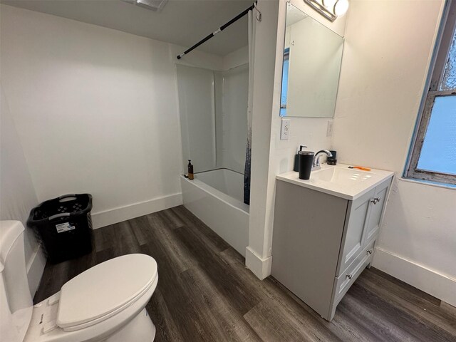 1100 Caledonia St, Butte, MT 59701 - full bathroom with wood finished floors, vanity, toilet, washtub / shower combination, and baseboards