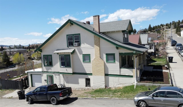 1100 Caledonia St, Butte, MT 59701 - view of front of home featuring a chimney, an attached garage, and cooling unit