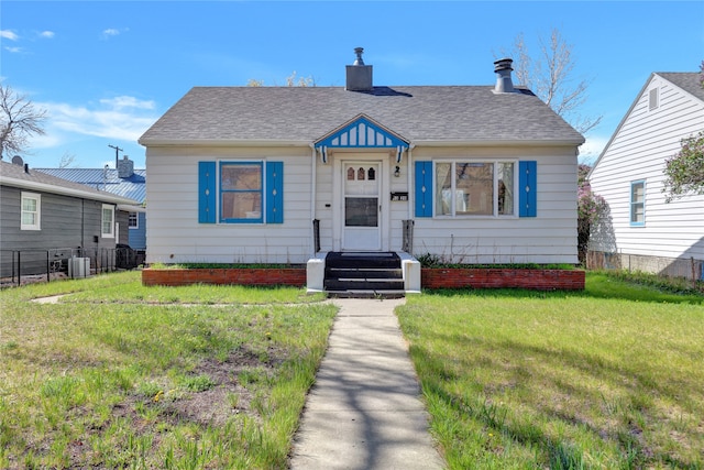 1320 1st Ave S, Great Falls, MT 59401 - bungalow-style house with central AC, roof with shingles, and a chimney