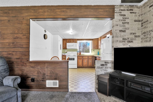 1320 1st Ave S, Great Falls, MT 59401 - kitchen with white appliances, brown cabinetry, light countertops, and light floors