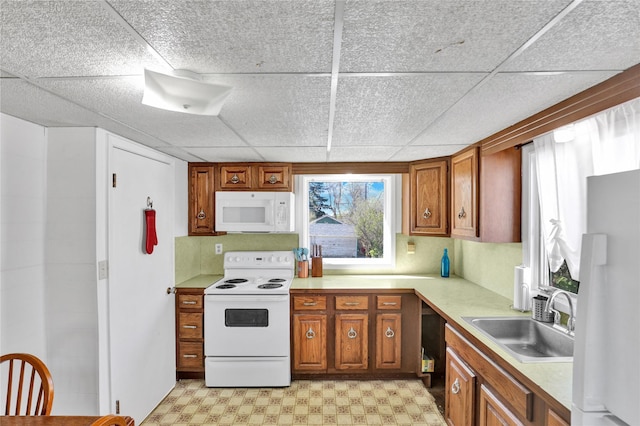 1320 1st Ave S, Great Falls, MT 59401 - kitchen with white appliances, a sink, light floors, light countertops, and a paneled ceiling