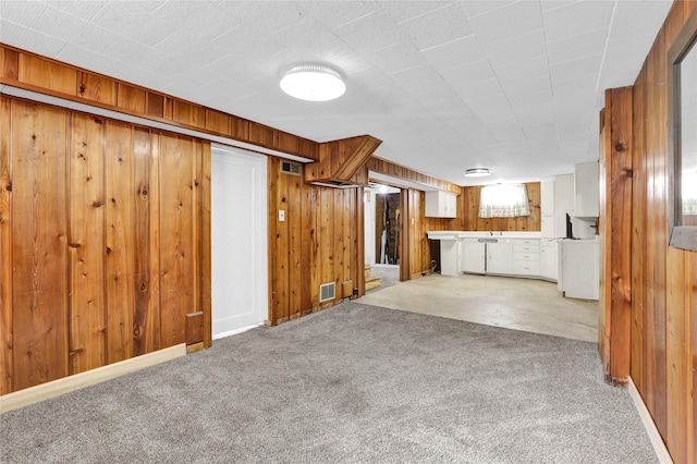 1320 1st Ave S, Great Falls, MT 59401 - unfurnished living room featuring carpet floors and wood walls