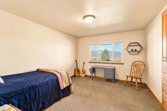 bedroom featuring carpet and baseboards