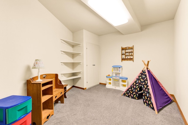 recreation room with carpet floors and baseboards