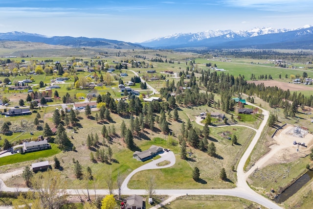 aerial view of property and surrounding area with a mountain backdrop