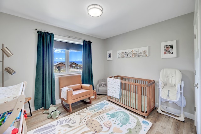217 Spring St, Townsend, MT 59644 - bedroom featuring wood finished floors and a nursery area