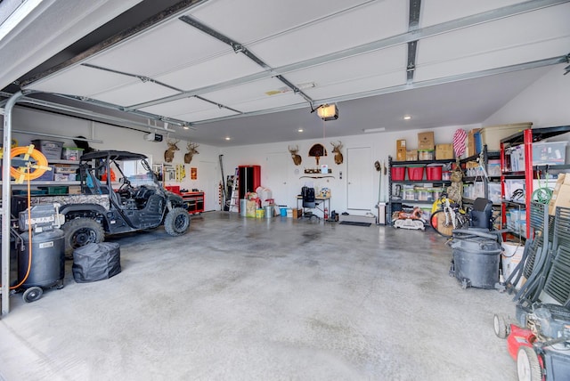 garage featuring a garage door opener and a workshop area