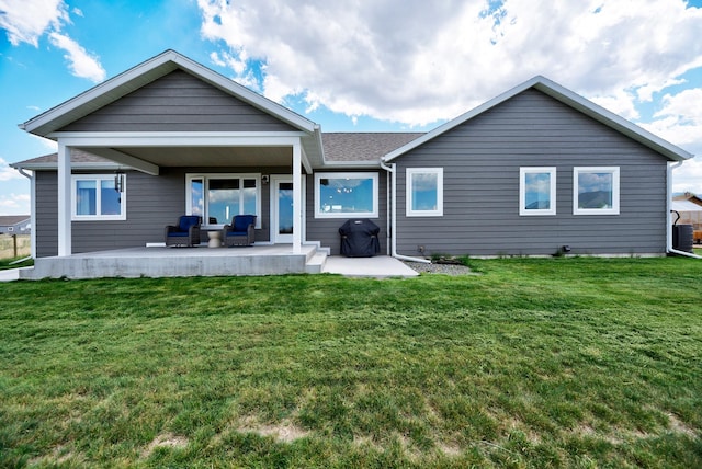 back of house with a patio area, a yard, and central AC