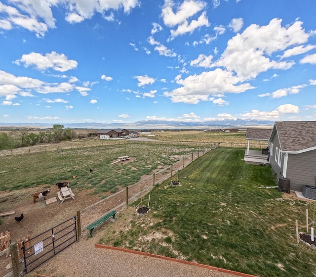 view of yard featuring a rural view and central air condition unit