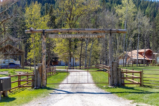 1492 Mcmannamy Draw, Kalispell, MT 59901 - surrounding community with a gate, a wooded view, and dirt driveway