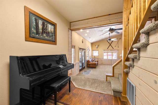 1492 Mcmannamy Draw, Kalispell, MT 59901 - sitting room featuring wood finished floors, stairs, a wainscoted wall, a ceiling fan, and wood walls