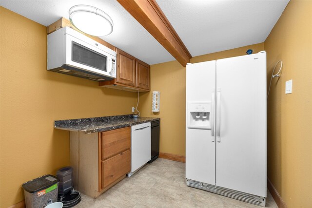 1492 Mcmannamy Draw, Kalispell, MT 59901 - kitchen featuring white appliances, brown cabinetry, and light flooring