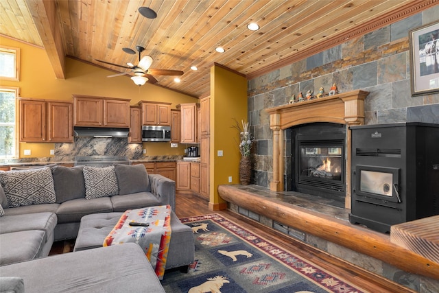 1492 Mcmannamy Draw, Kalispell, MT 59901 - living area with a tile fireplace, wood ceiling, wood finished floors, a ceiling fan, and vaulted ceiling