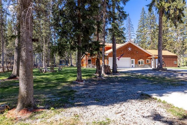 1492 Mcmannamy Draw, Kalispell, MT 59901 - view of front of home featuring an attached garage, a front yard, and gravel driveway