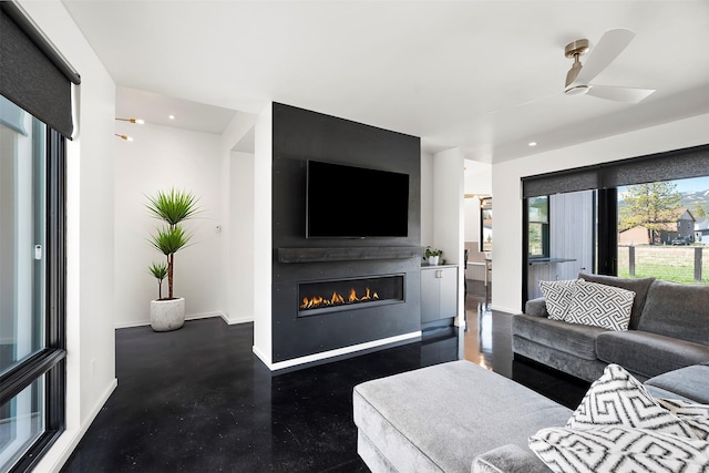 772 Denver St Unit A & B, Whitefish, MT 59937 - living room featuring a glass covered fireplace, ceiling fan, baseboards, recessed lighting, and finished concrete floors