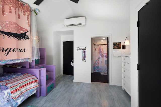 772 Denver St Unit A & B, Whitefish, MT 59937 - bedroom with a wall unit AC, wood finished floors, and lofted ceiling