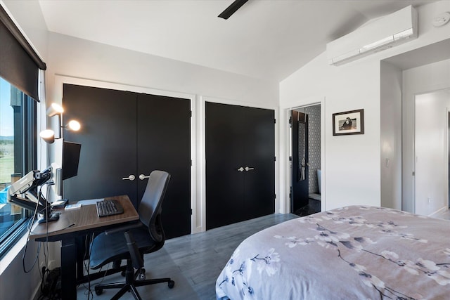 772 Denver St Unit A & B, Whitefish, MT 59937 - bedroom featuring a wall mounted AC, vaulted ceiling, a desk, and multiple closets