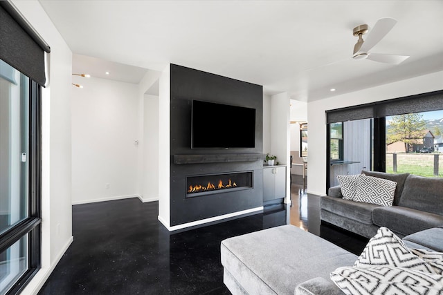 772 Denver St Unit A & B, Whitefish, MT 59937 - living area featuring a glass covered fireplace, baseboards, a ceiling fan, recessed lighting, and concrete floors