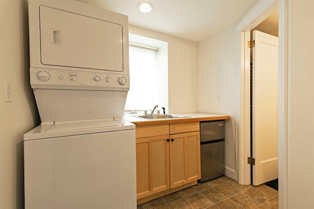 300 Evans Ave, Missoula, MT 59801 - washroom featuring estacked washer and dryer and dark tile patterned flooring
