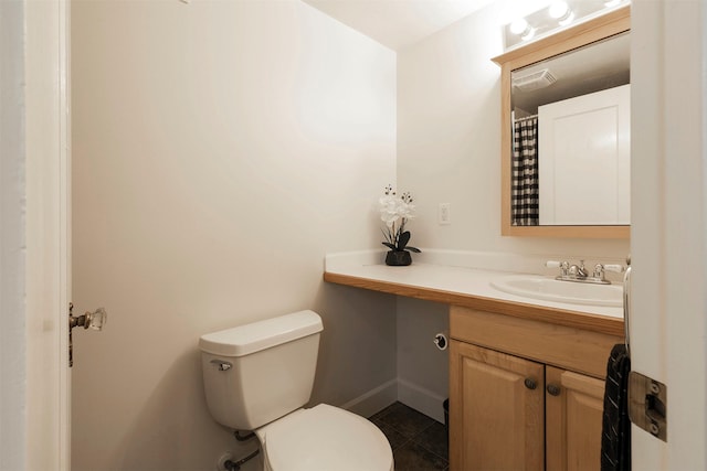 300 Evans Ave, Missoula, MT 59801 - bathroom featuring vanity, toilet, tile patterned flooring, and baseboards