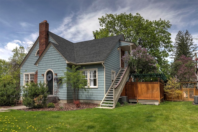300 Evans Ave, Missoula, MT 59801 - view of front facade with stairway, a chimney, roof with shingles, and cooling unit