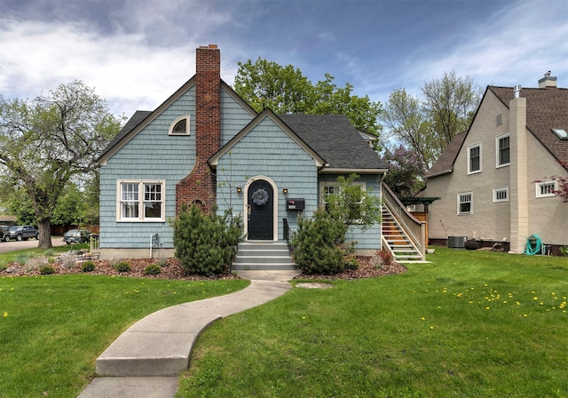 300 Evans Ave, Missoula, MT 59801 - view of front facade featuring a chimney, a front lawn, central AC unit, and stairway