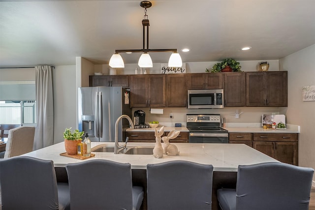 517 Raven Ln, Kalispell, MT 59901 - kitchen featuring appliances with stainless steel finishes, pendant lighting, a breakfast bar, and recessed lighting