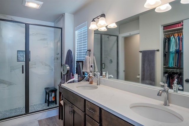517 Raven Ln, Kalispell, MT 59901 - full bathroom featuring a shower stall, double vanity, and a walk in closet